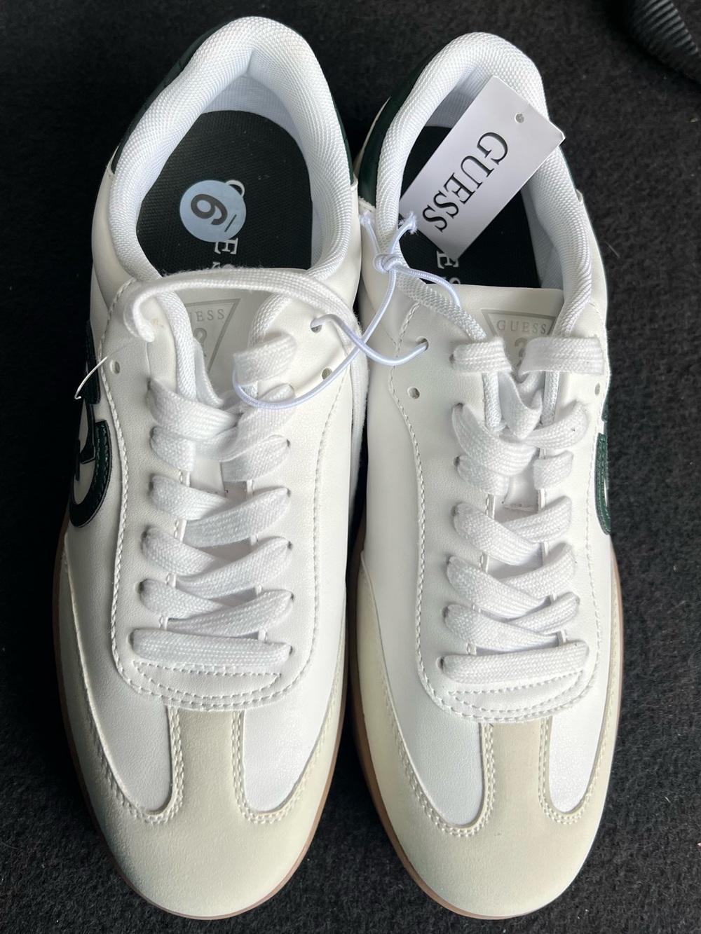 GUESS White Sneakers with Green Circle G Logo Accents.